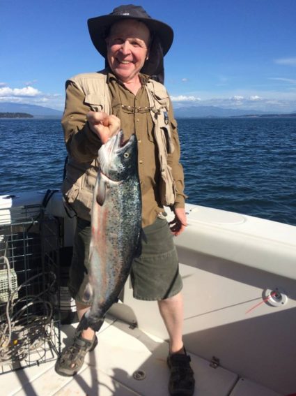 AHS science teacher Victor Garcia after he hooked a wild salmon in the san Juan Islands.